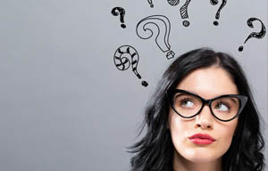 Woman with quizzical expression and question marks floating above her head.